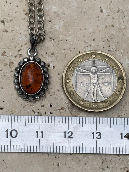 Amber, pendant measuring 25x13x5 millimeters, sold with a 42 centimeter black leather cord!