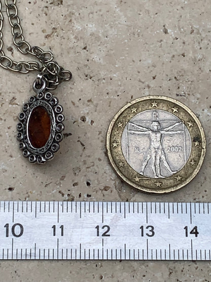 Amber, pendant measuring 25x13x5 millimeters, sold with a 42 centimeter black leather cord!
