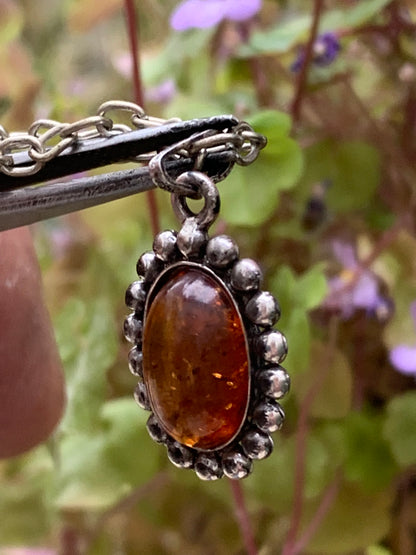 Amber, pendant measuring 25x13x5 millimeters, sold with a 42 centimeter black leather cord!