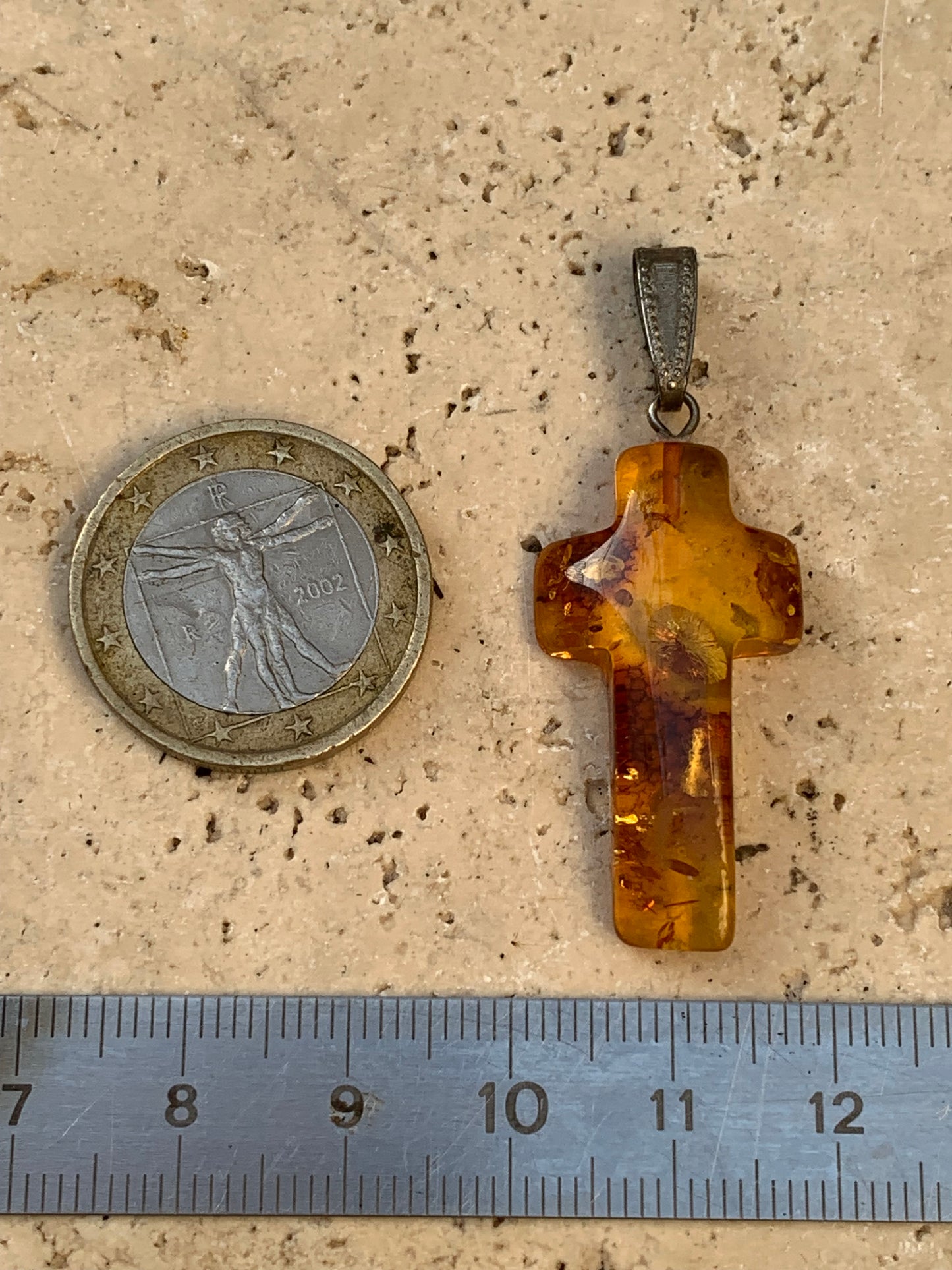 Amber, 'cross' shaped pendant measuring 40 x 18 x 7 millimeters, sold with a sliding (adjustable) black leather cord measuring 40 to 70 centimeters!