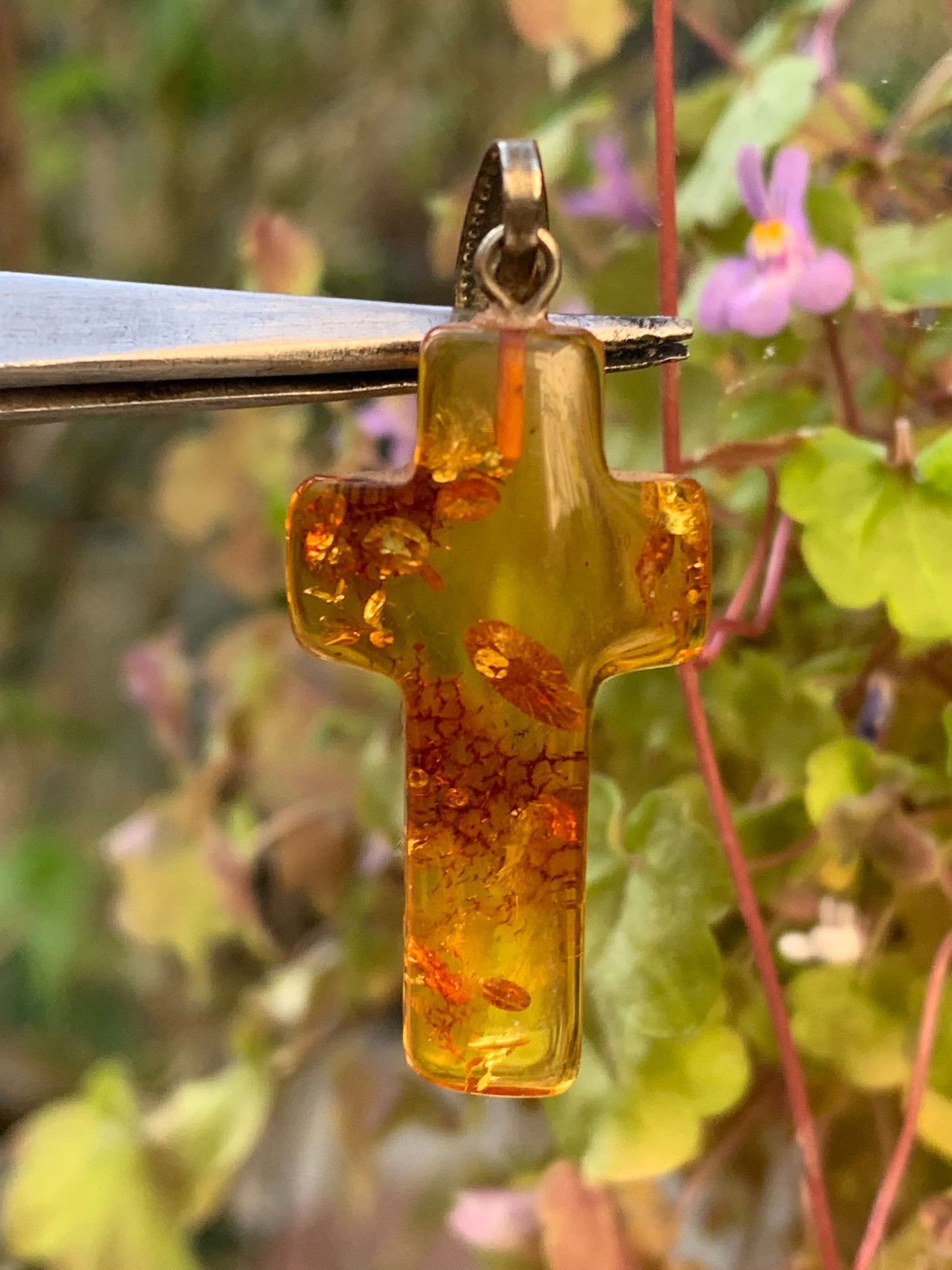 Amber, 'cross' shaped pendant measuring 40 x 18 x 7 millimeters, sold with a sliding (adjustable) black leather cord measuring 40 to 70 centimeters!