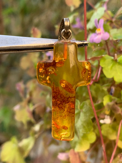 Amber, 'cross' shaped pendant measuring 40 x 18 x 7 millimeters, sold with a sliding (adjustable) black leather cord measuring 40 to 70 centimeters!