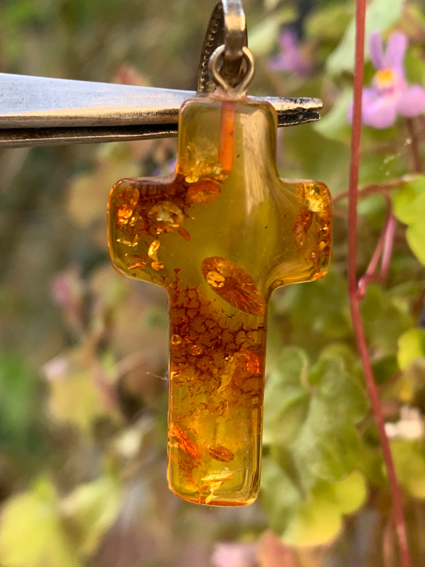 Amber, 'cross' shaped pendant measuring 40 x 18 x 7 millimeters, sold with a sliding (adjustable) black leather cord measuring 40 to 70 centimeters!