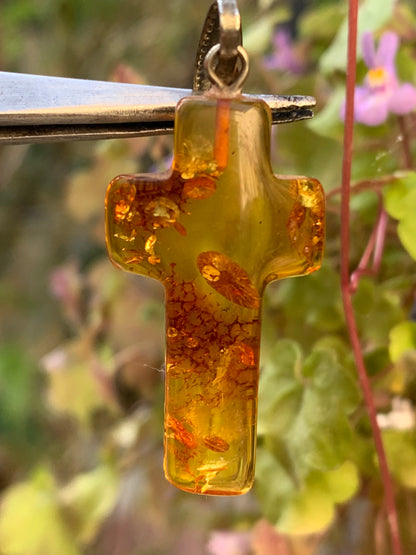 Amber, 'cross' shaped pendant measuring 40 x 18 x 7 millimeters, sold with a sliding (adjustable) black leather cord measuring 40 to 70 centimeters!