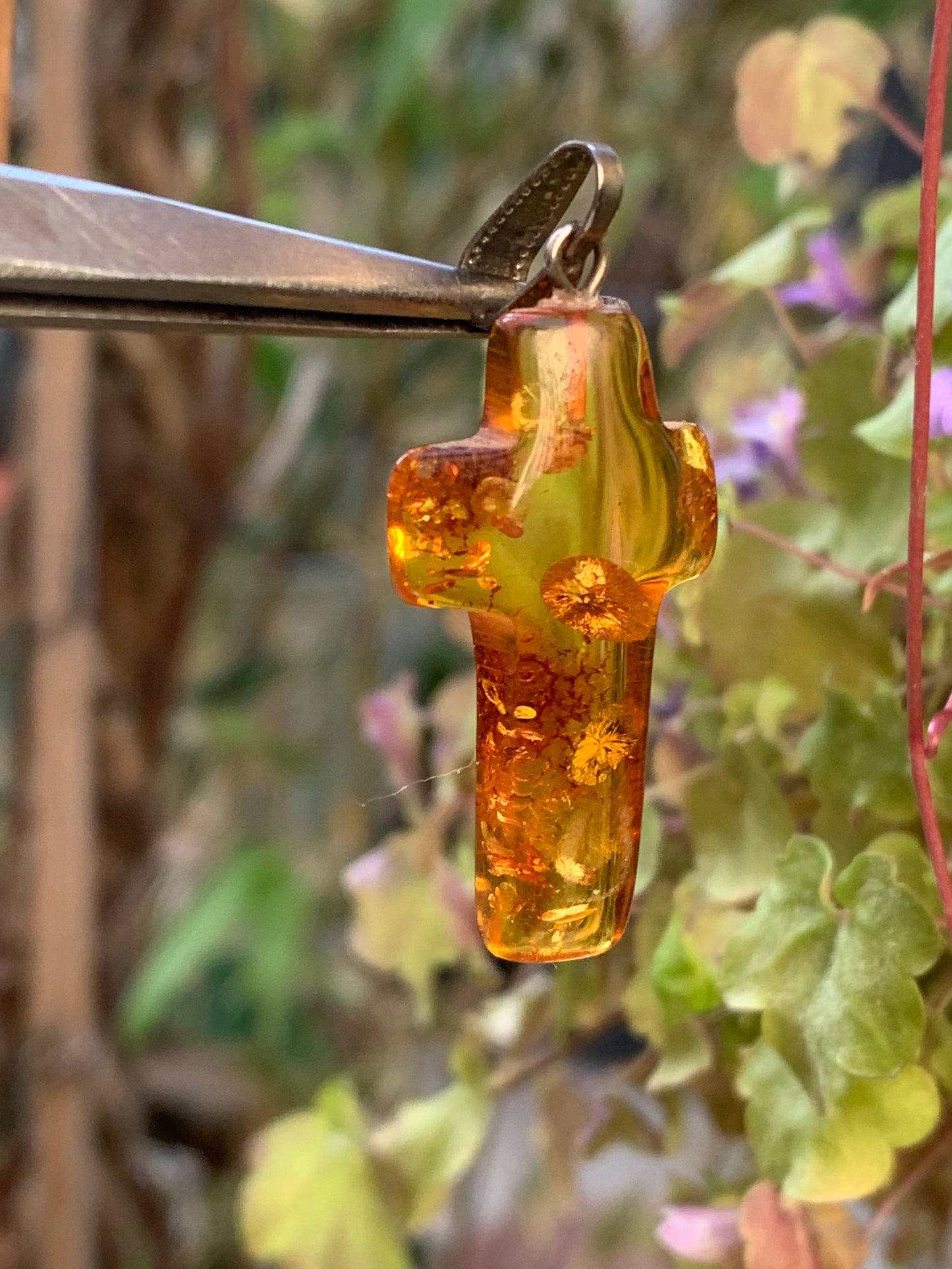 Amber, 'cross' shaped pendant measuring 40 x 18 x 7 millimeters, sold with a sliding (adjustable) black leather cord measuring 40 to 70 centimeters!