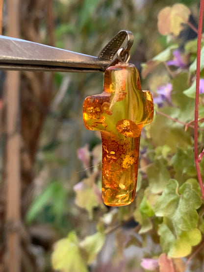 Amber, 'cross' shaped pendant measuring 40 x 18 x 7 millimeters, sold with a sliding (adjustable) black leather cord measuring 40 to 70 centimeters!