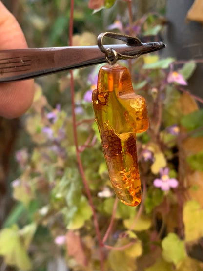 Amber, 'cross' shaped pendant measuring 40 x 18 x 7 millimeters, sold with a sliding (adjustable) black leather cord measuring 40 to 70 centimeters!