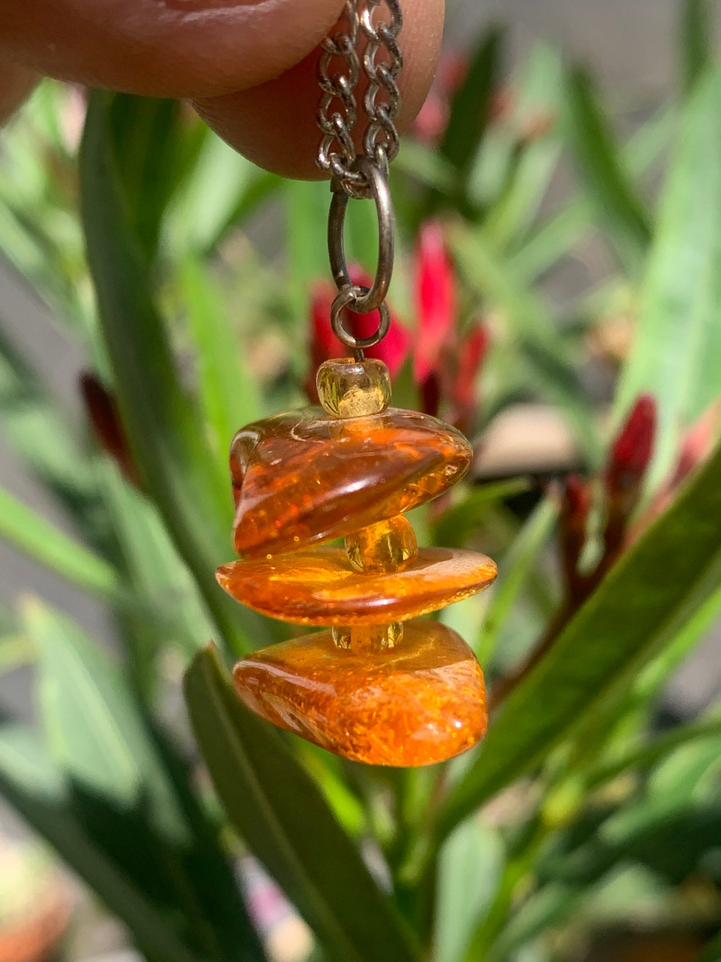Amber, pendant of 3 polished natural pebbles measuring 32x30x15 millimeters, sold with a sliding cord (adjustable), in black leather from 40 to 70 centimeters!