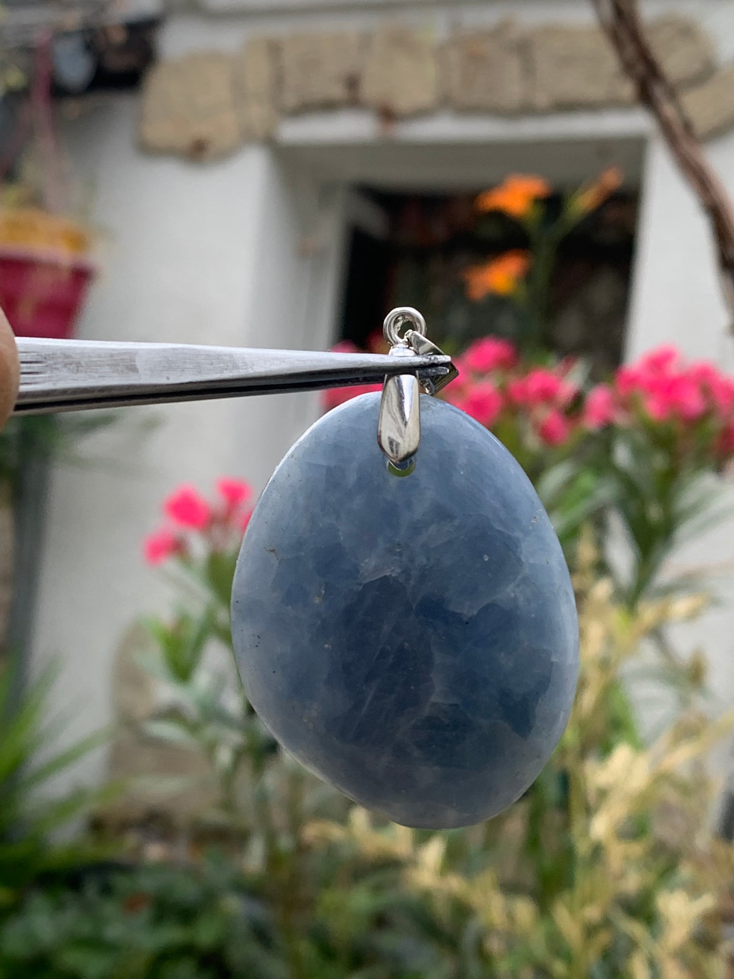 Blue calcite, pendant measuring 47mm high x 37mm wide x 18mm deep. Sold with an adjustable black cord!