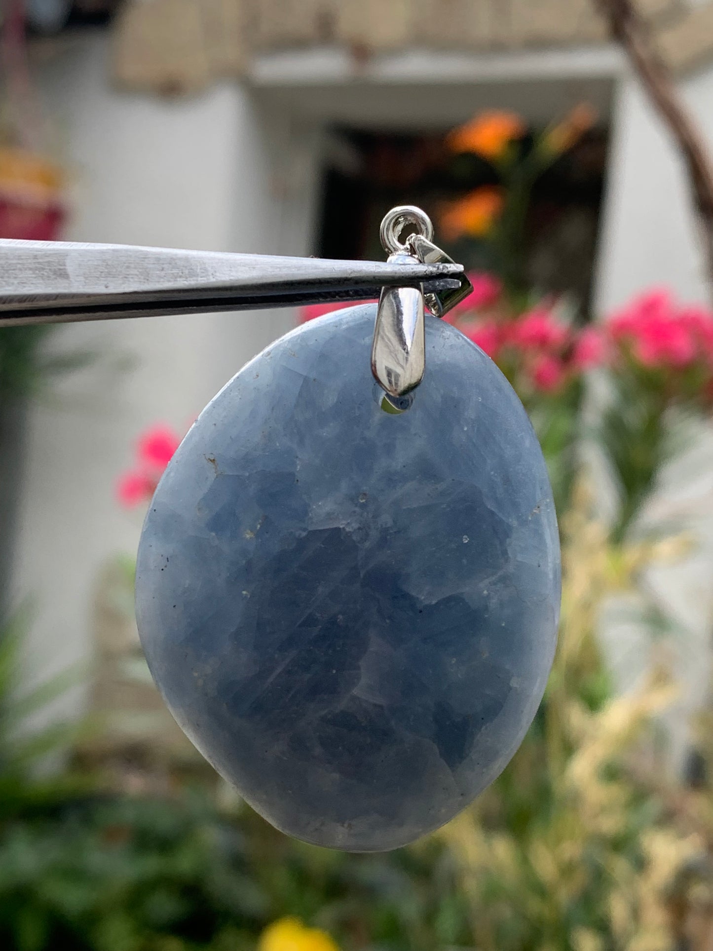 Blue calcite, pendant measuring 47mm high x 37mm wide x 18mm deep. Sold with an adjustable black cord!