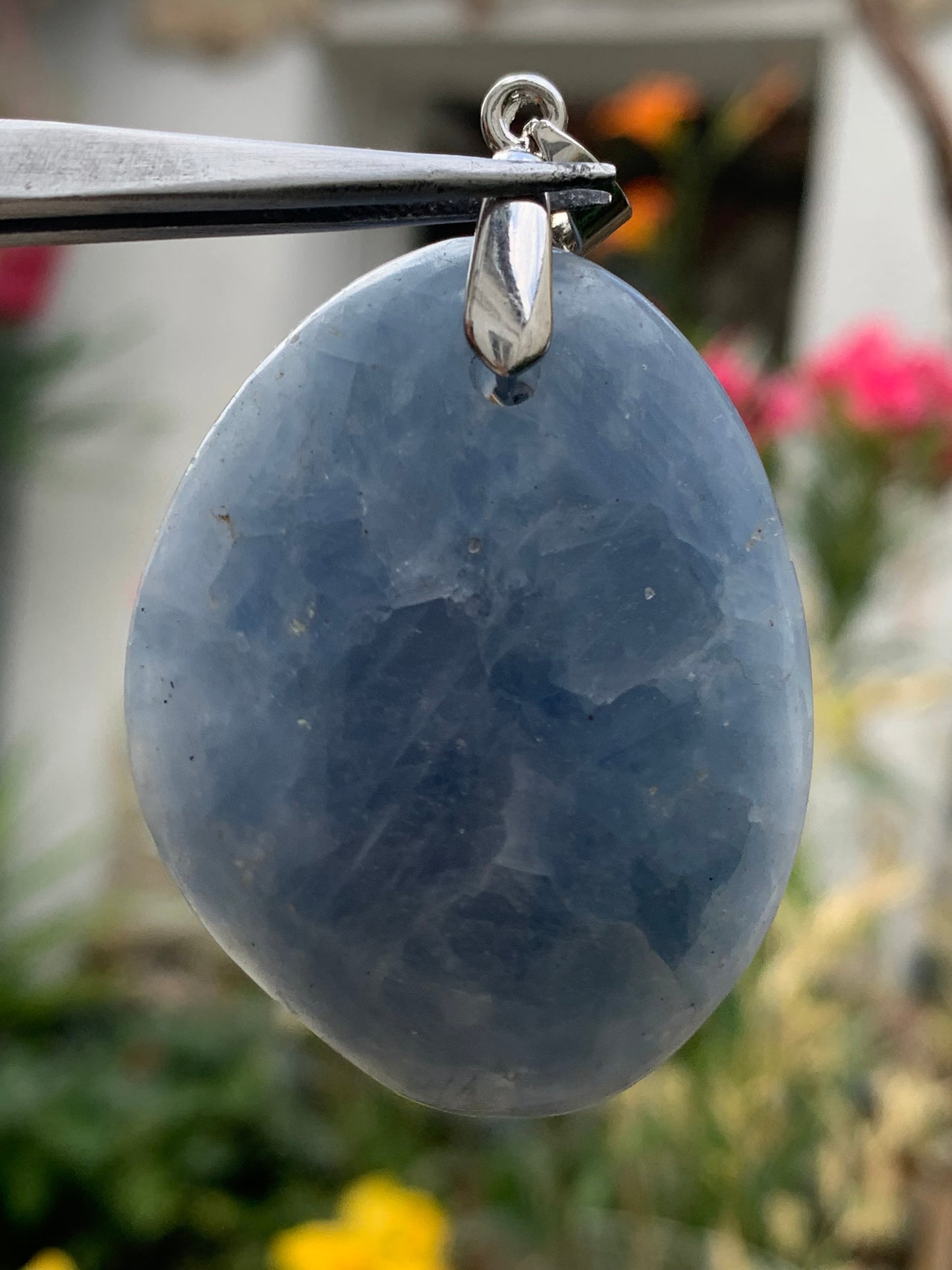 Blue calcite, pendant measuring 47mm high x 37mm wide x 18mm deep. Sold with an adjustable black cord!