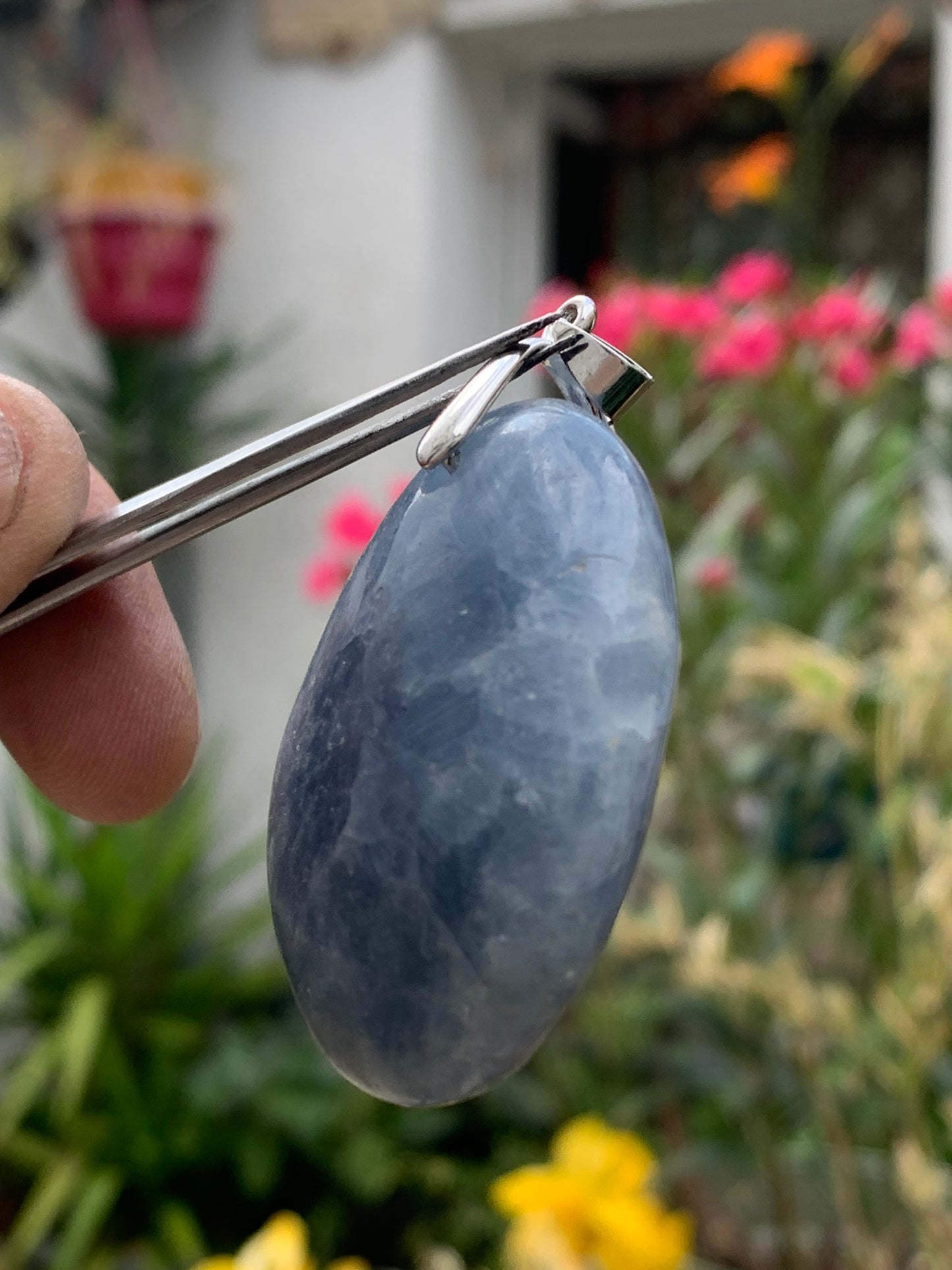 Blue calcite, pendant measuring 47mm high x 37mm wide x 18mm deep. Sold with an adjustable black cord!