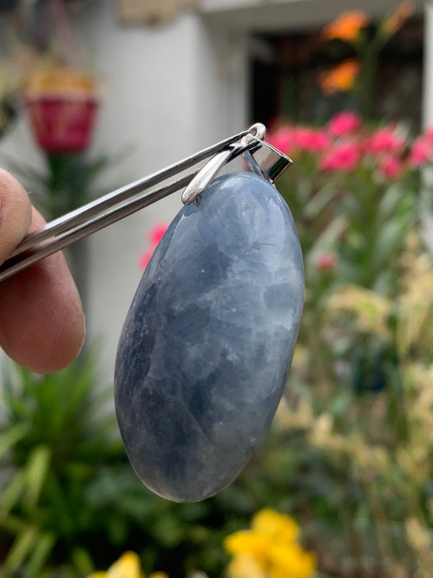 Blue calcite, pendant measuring 47mm high x 37mm wide x 18mm deep. Sold with an adjustable black cord!