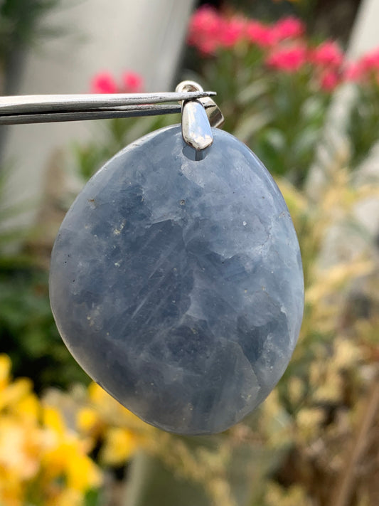 Blue calcite, pendant measuring 47mm high x 37mm wide x 18mm deep. Sold with an adjustable black cord!
