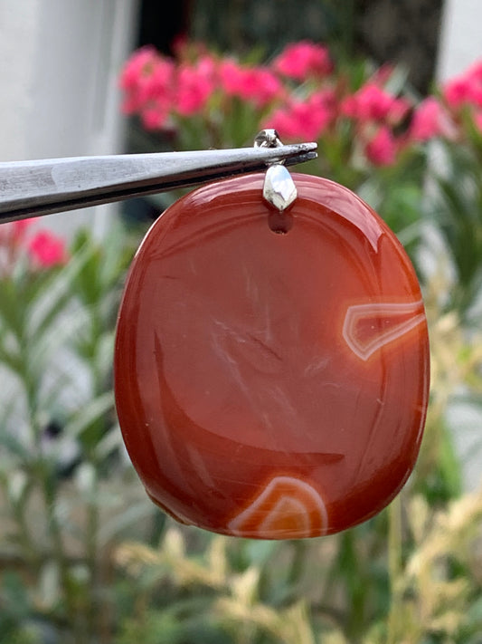 Carnelian, pendant measuring 55mm high x 38mm wide x 9mm thick. Sold with an adjustable black cord!