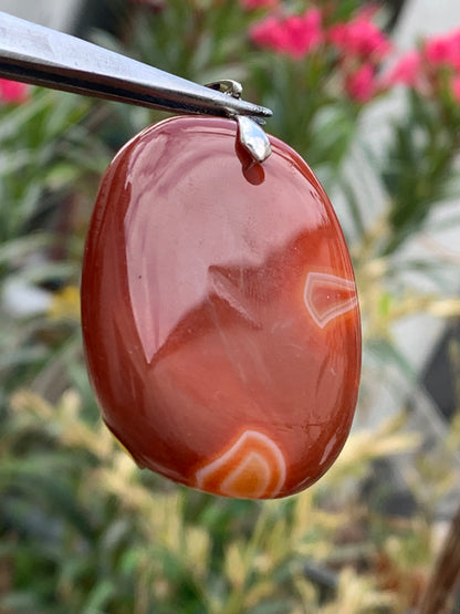 Carnelian, pendant measuring 55mm high x 38mm wide x 9mm thick. Sold with an adjustable black cord!