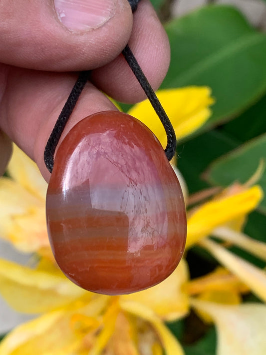 Carnelian, pendant measuring 31mm high x 23mm wide x 12mm thick. Sold with an adjustable black cord!