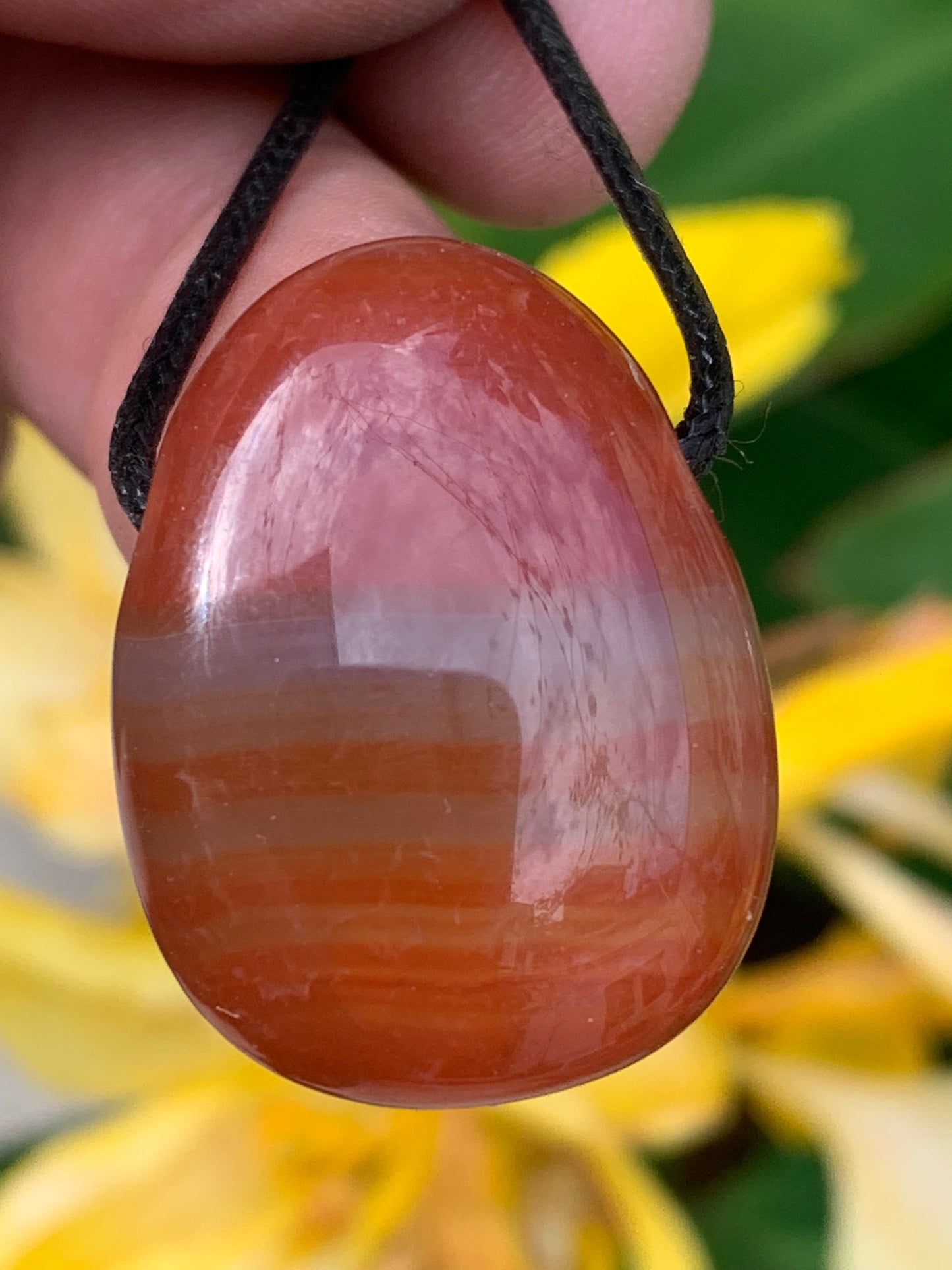 Carnelian, pendant measuring 31mm high x 23mm wide x 12mm thick. Sold with an adjustable black cord!
