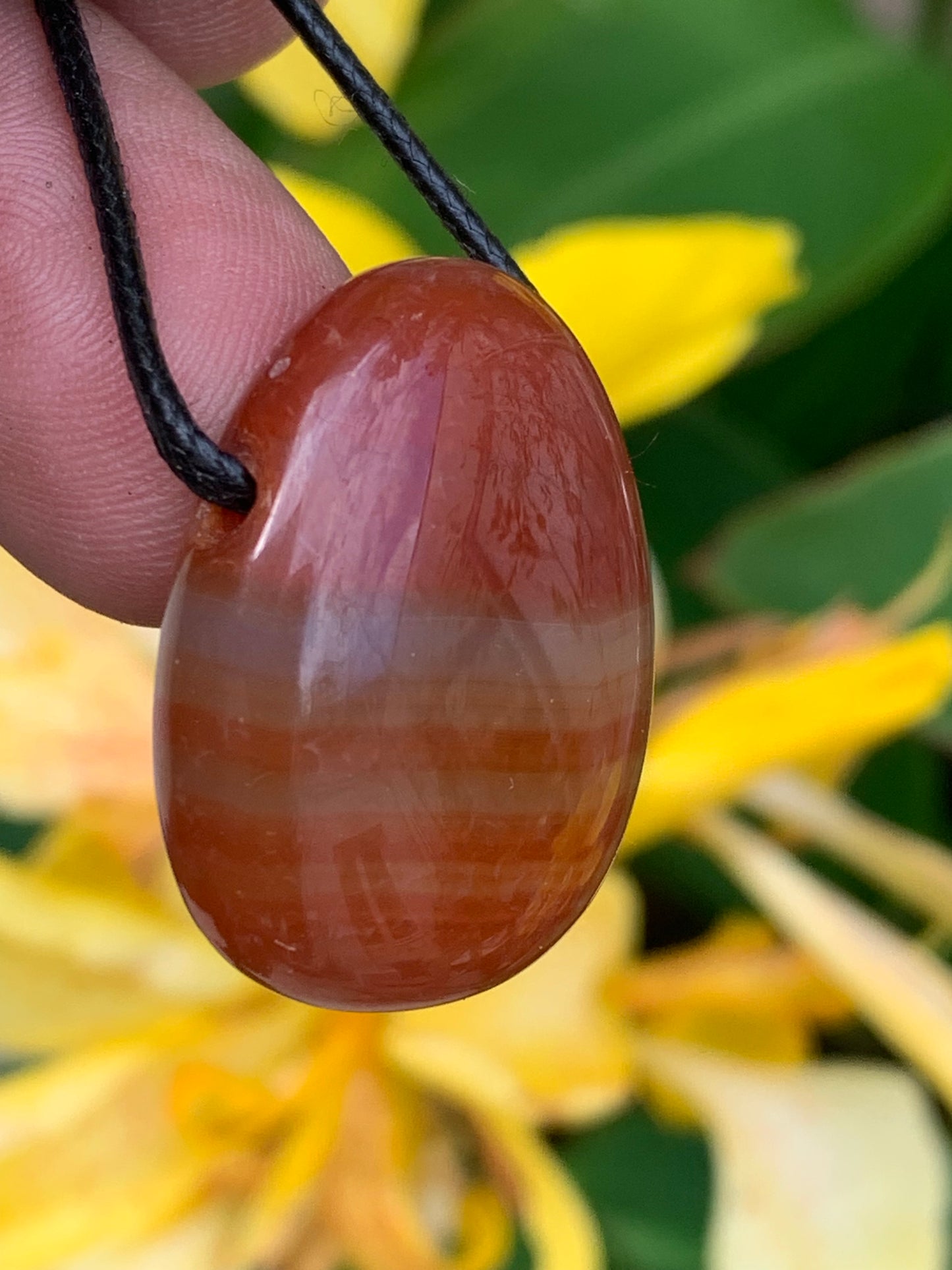 Carnelian, pendant measuring 31mm high x 23mm wide x 12mm thick. Sold with an adjustable black cord!