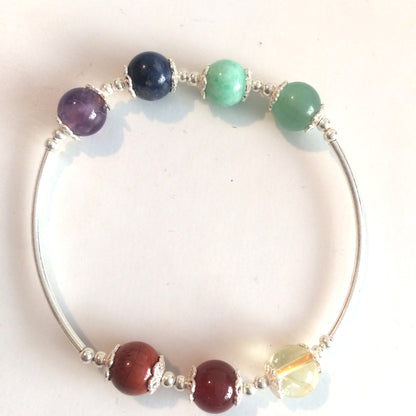'7 Chakras' bracelet, with 8 millimeter beads and 100% silver tubes. Available in lengths of 17 to 21 cm. AA to AAA quality, superb beads! Made by Gem &amp; Zen