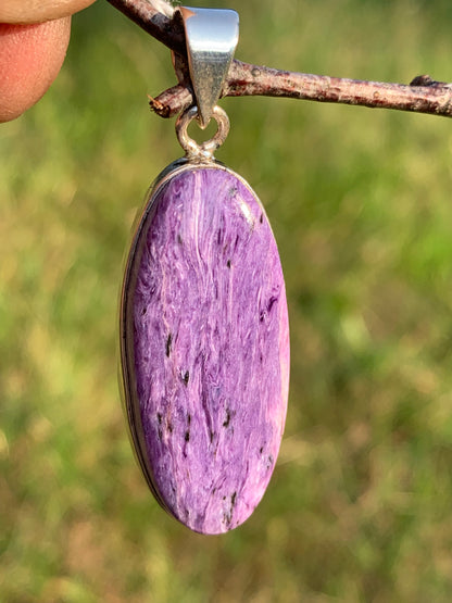 Charoite, pendant set in solid silver measuring 50mm x 17 x 8. Sold with adjustable black cord, ready to wear!