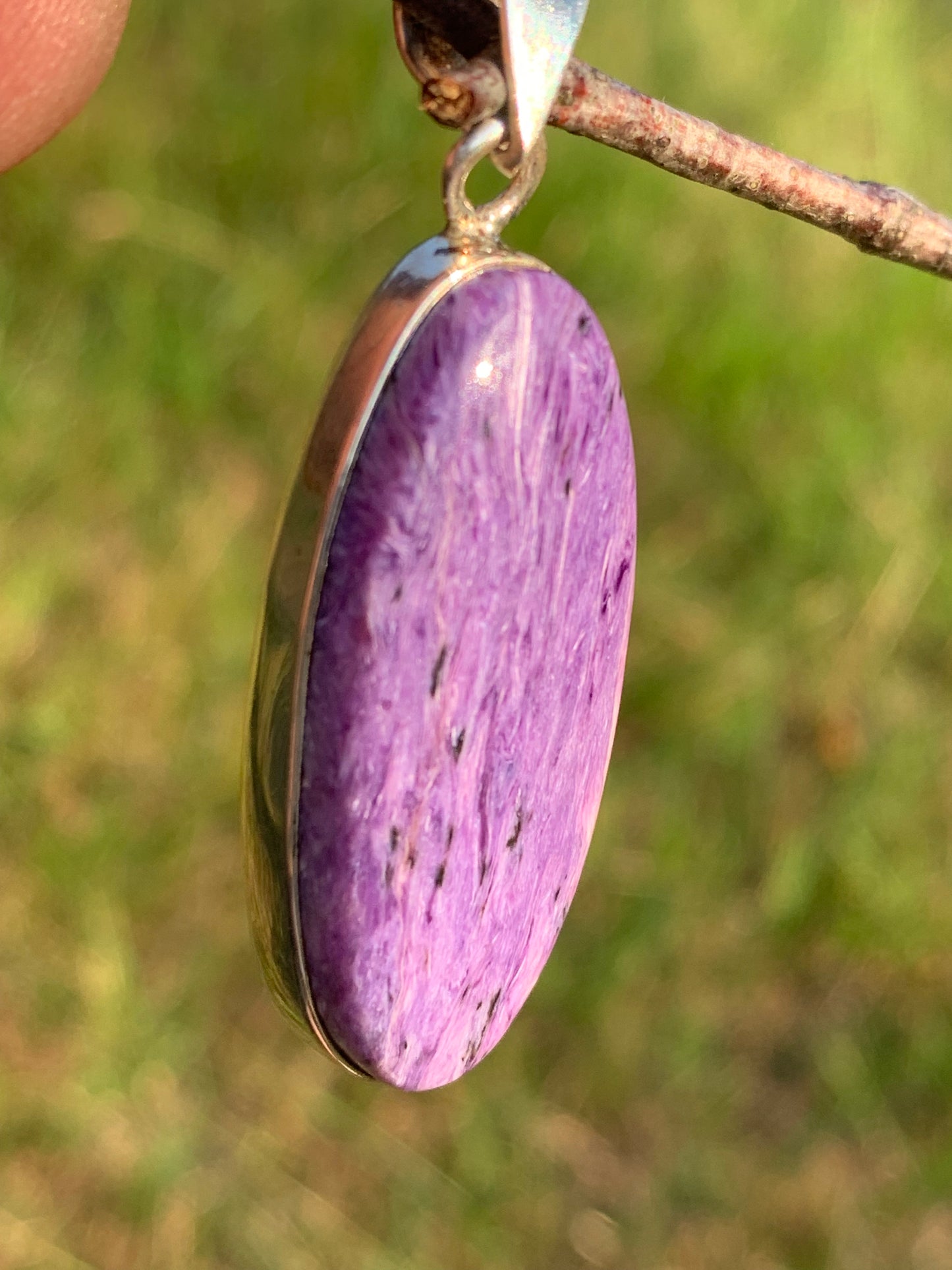 Charoite, pendant set in solid silver measuring 50mm x 17 x 8. Sold with adjustable black cord, ready to wear!