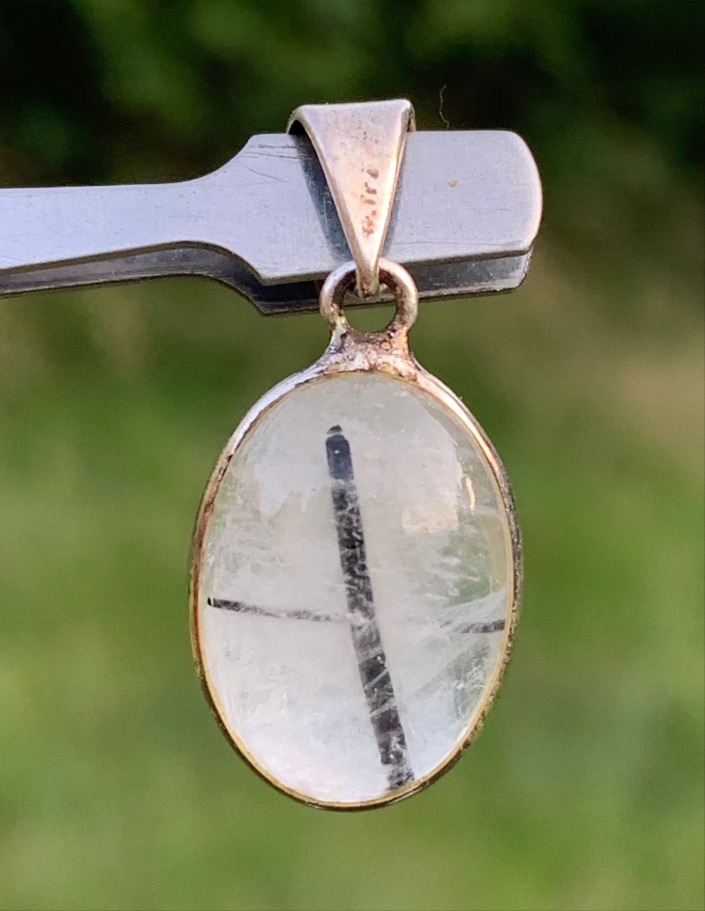 Rock crystal/quartz with black tourmaline inclusions! Silver pendant, 28mm high x13 x7. Sold with an adjustable black cord!