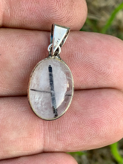 Rock crystal/quartz with black tourmaline inclusions! Silver pendant, 28mm high x13 x7. Sold with an adjustable black cord!