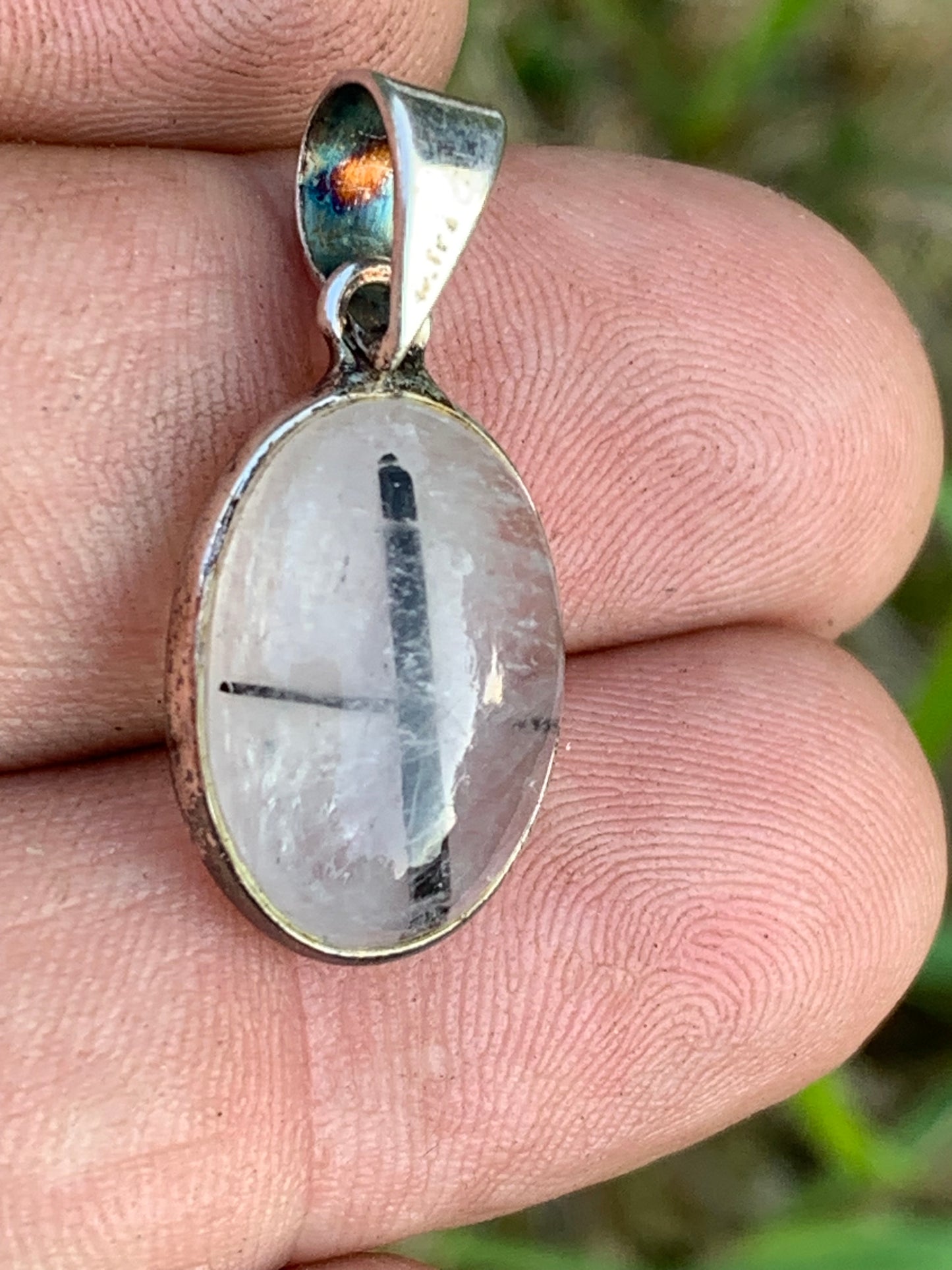 Rock crystal/quartz with black tourmaline inclusions! Silver pendant, 28mm high x13 x7. Sold with an adjustable black cord!