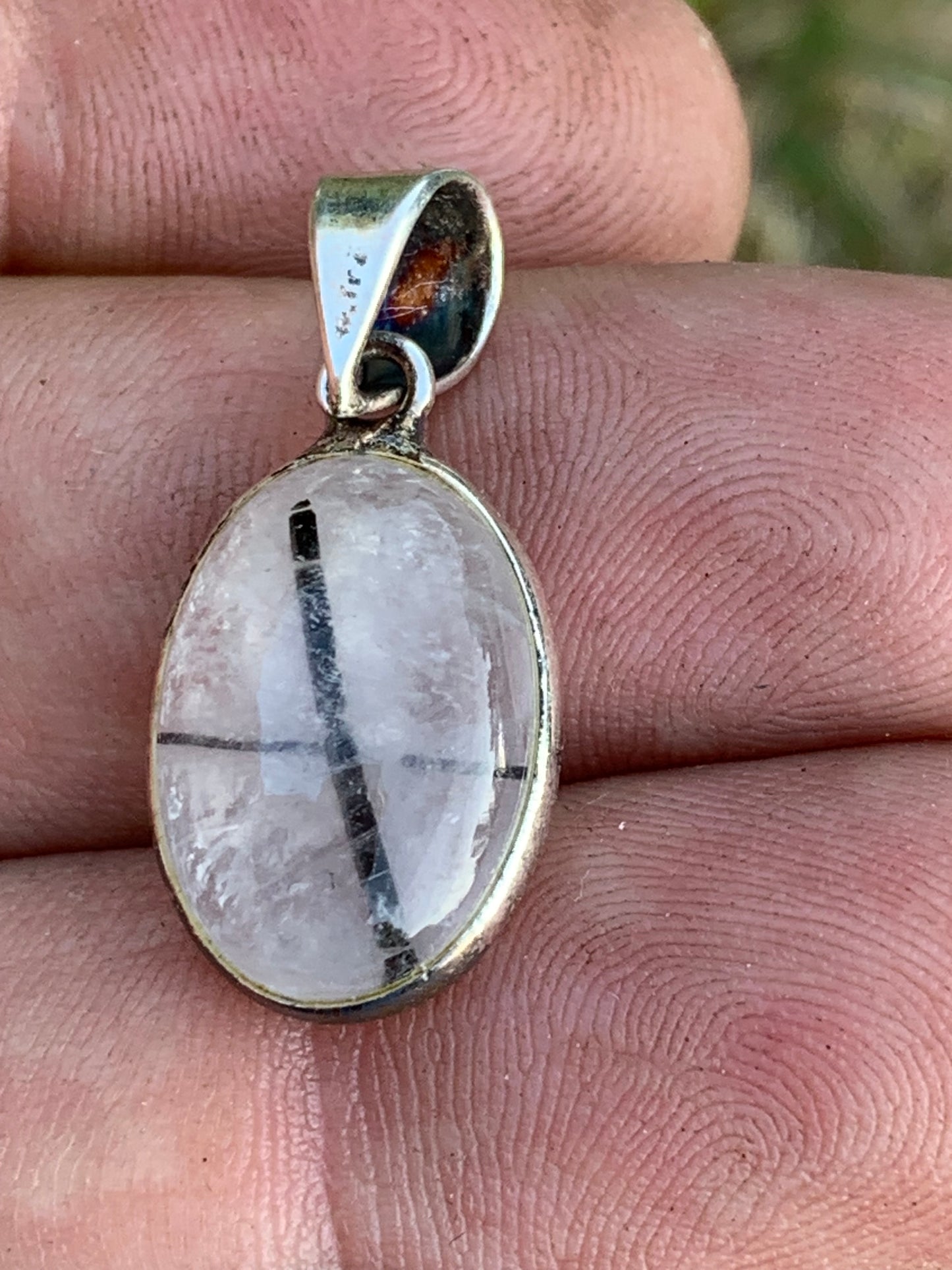 Rock crystal/quartz with black tourmaline inclusions! Silver pendant, 28mm high x13 x7. Sold with an adjustable black cord!