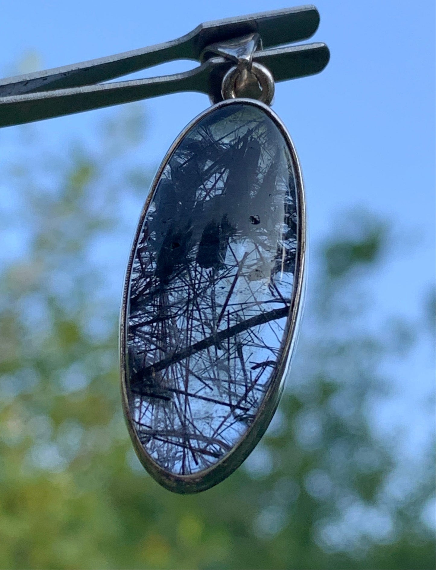 Rock crystal/quartz with black tourmaline inclusions! Silver pendant, 45mm high x15 x8. Sold with adjustable black cord!