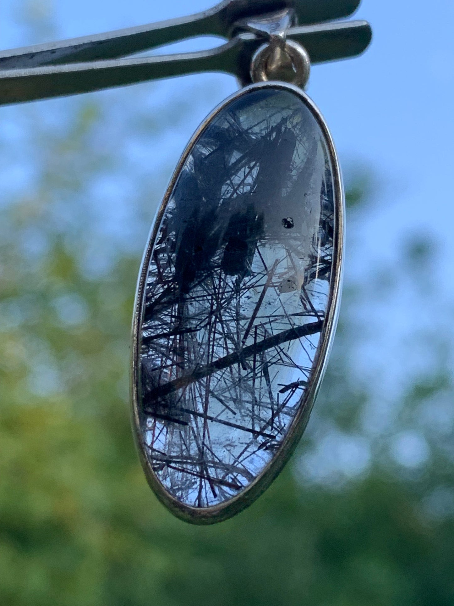 Rock crystal/quartz with black tourmaline inclusions! Silver pendant, 45mm high x15 x8. Sold with adjustable black cord!