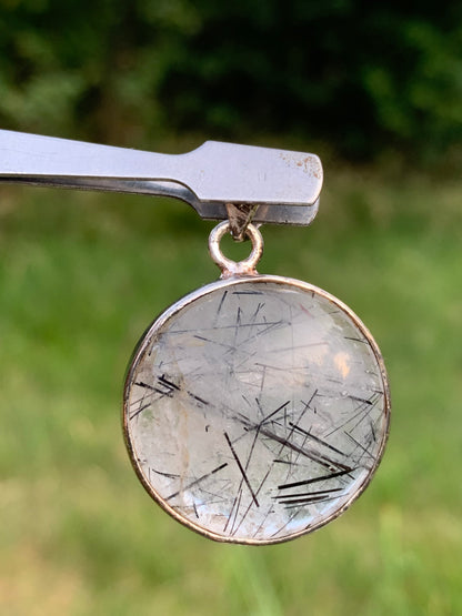 Rock crystal/quartz with black tourmaline inclusions! Silver pendant, 35mm high x26 x8. Sold with an adjustable black cord!