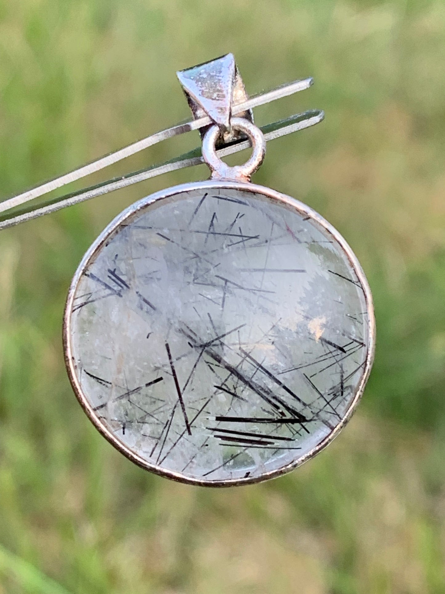 Rock crystal/quartz with black tourmaline inclusions! Silver pendant, 35mm high x26 x8. Sold with an adjustable black cord!