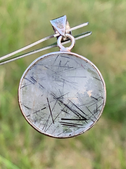 Rock crystal/quartz with black tourmaline inclusions! Silver pendant, 35mm high x26 x8. Sold with an adjustable black cord!