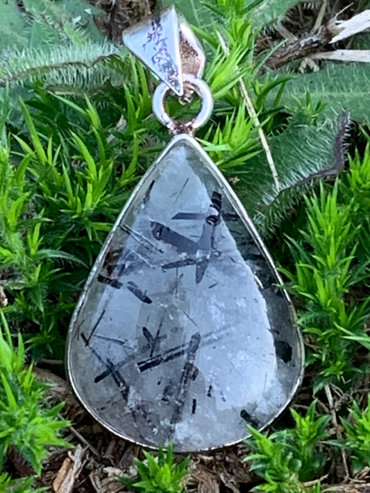 Rock crystal/quartz with black tourmaline inclusions! Silver pendant, 38mm high x21 x7. Sold with adjustable black cord!