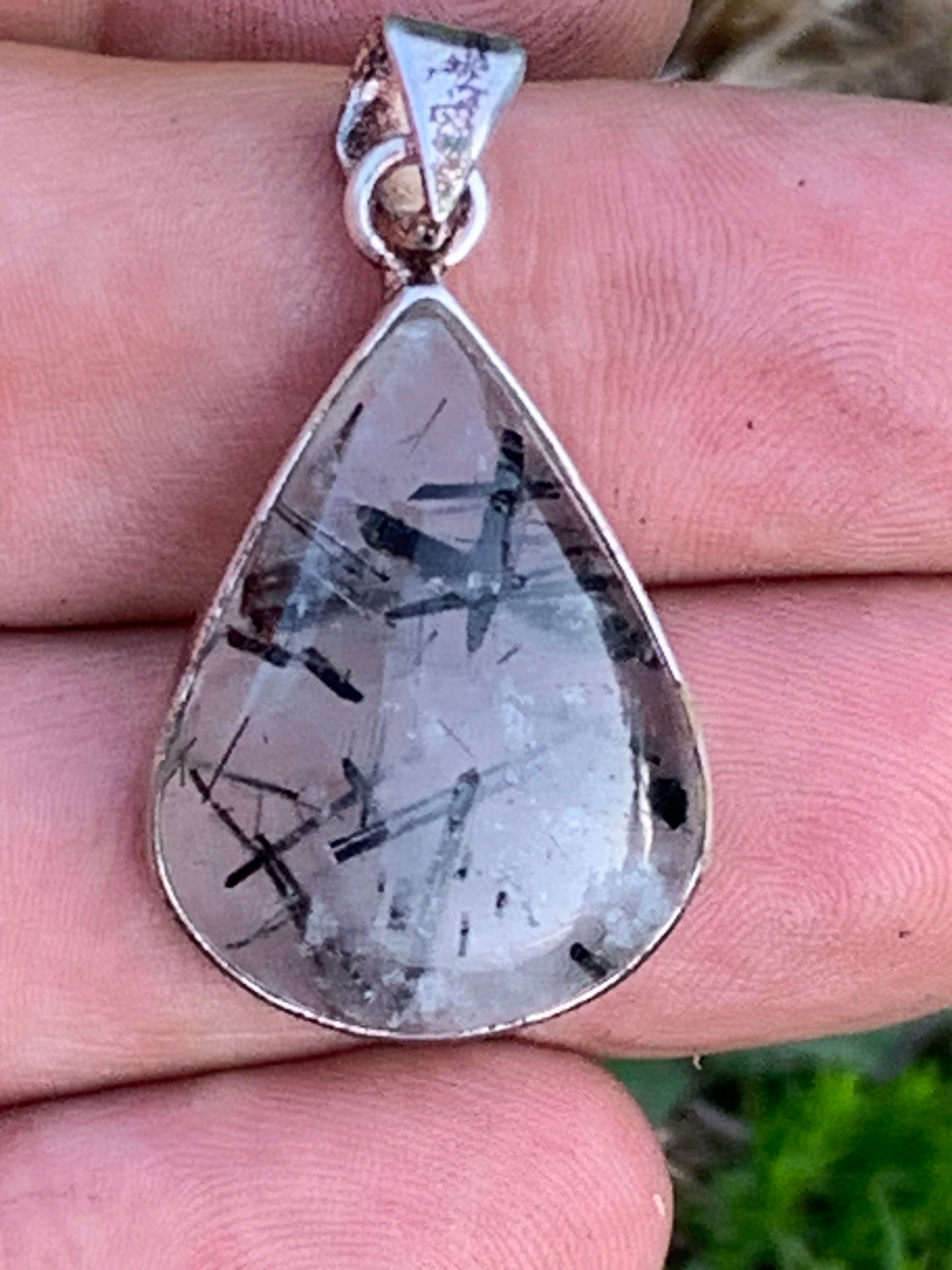 Rock crystal/quartz with black tourmaline inclusions! Silver pendant, 38mm high x21 x7. Sold with adjustable black cord!
