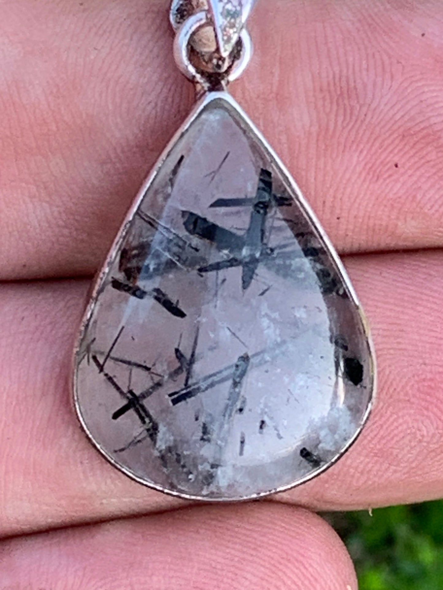 Rock crystal/quartz with black tourmaline inclusions! Silver pendant, 38mm high x21 x7. Sold with adjustable black cord!