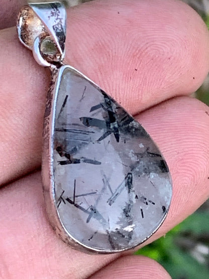Rock crystal/quartz with black tourmaline inclusions! Silver pendant, 38mm high x21 x7. Sold with adjustable black cord!