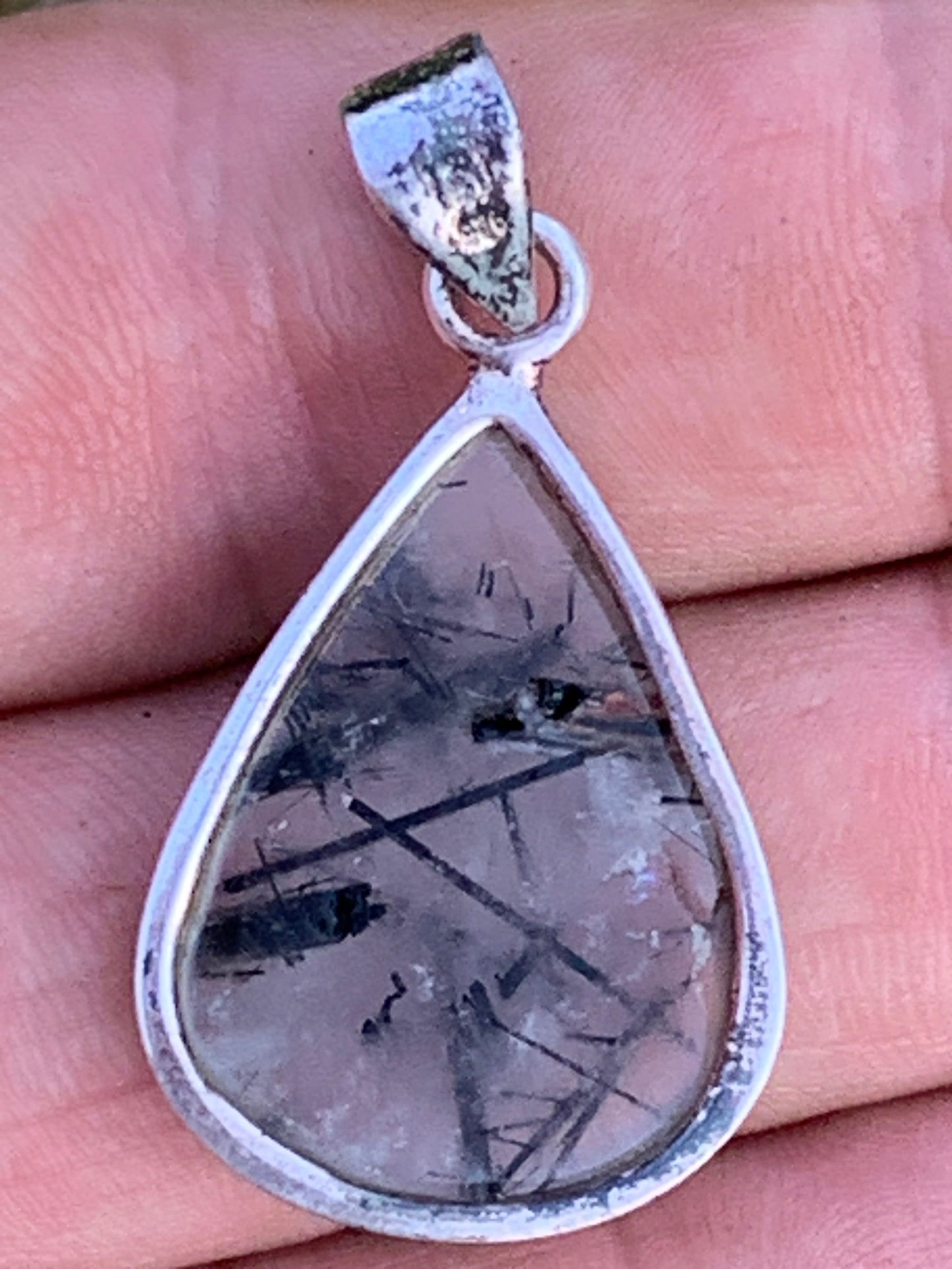 Rock crystal/quartz with black tourmaline inclusions! Silver pendant, 38mm high x21 x7. Sold with adjustable black cord!