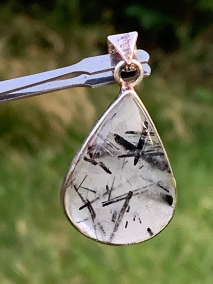 Rock crystal/quartz with black tourmaline inclusions! Silver pendant, 38mm high x21 x7. Sold with adjustable black cord!