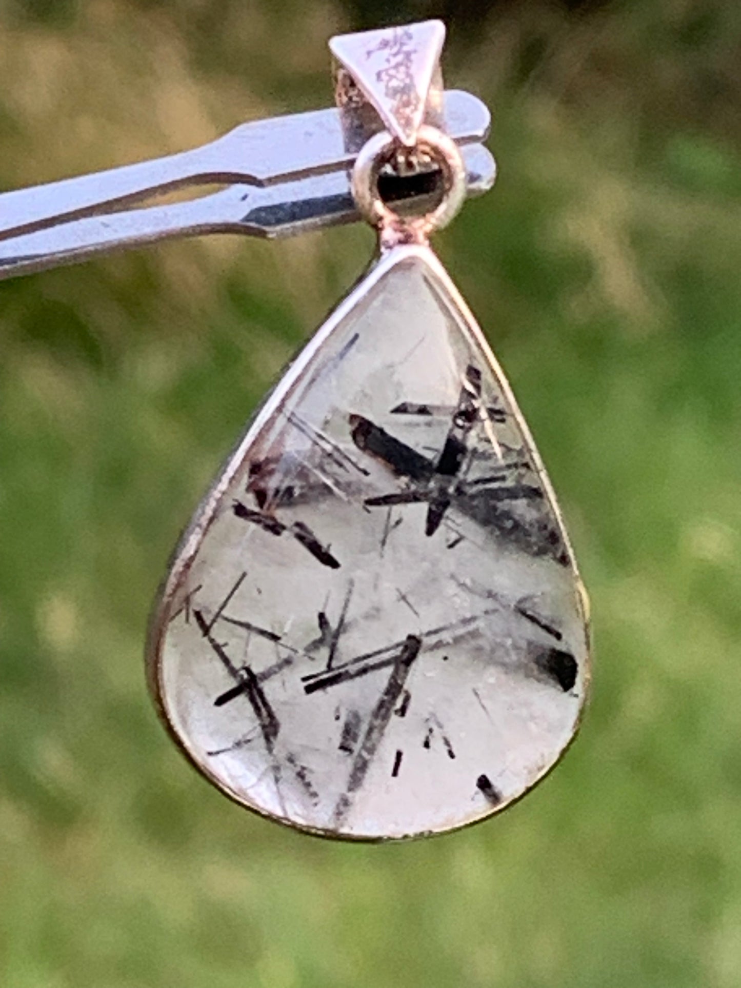 Rock crystal/quartz with black tourmaline inclusions! Silver pendant, 38mm high x21 x7. Sold with adjustable black cord!