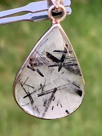 Rock crystal/quartz with black tourmaline inclusions! Silver pendant, 38mm high x21 x7. Sold with adjustable black cord!