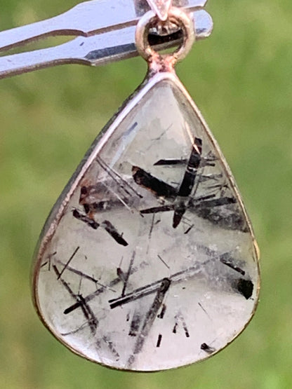 Rock crystal/quartz with black tourmaline inclusions! Silver pendant, 38mm high x21 x7. Sold with adjustable black cord!