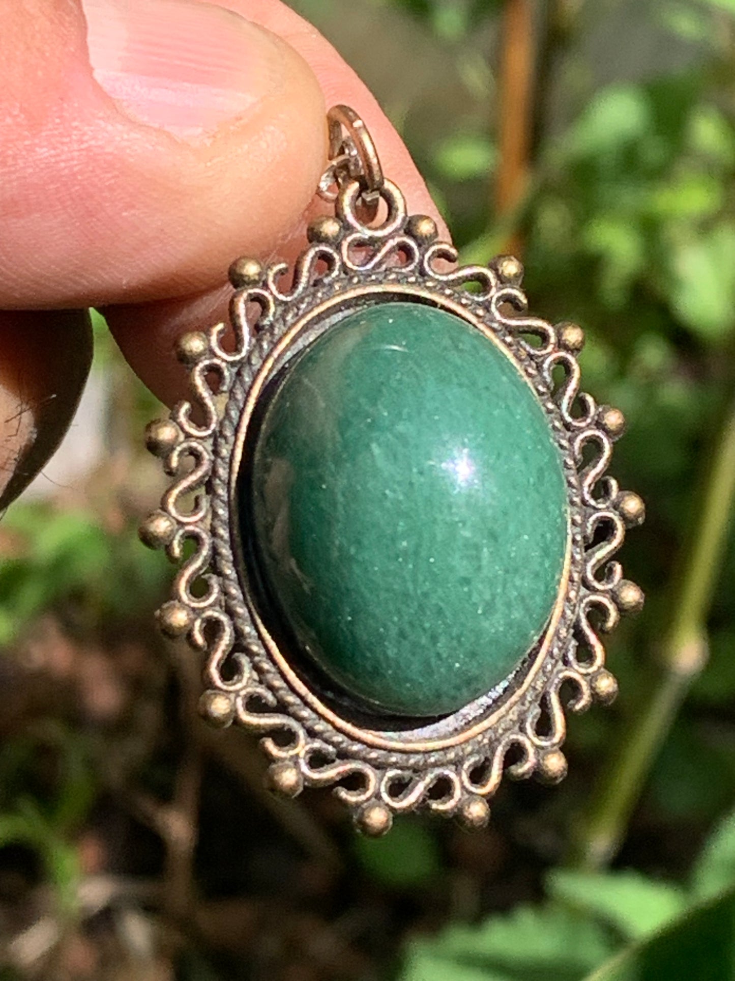 Bronze-colored medallion with Aventurine/green quartz, 36 mm high x 30 x 3. Sold with an adjustable black cord!