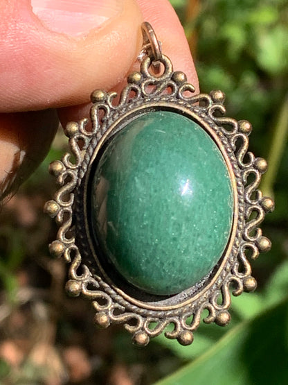 Bronze-colored medallion with Aventurine/green quartz, 36 mm high x 30 x 3. Sold with an adjustable black cord!