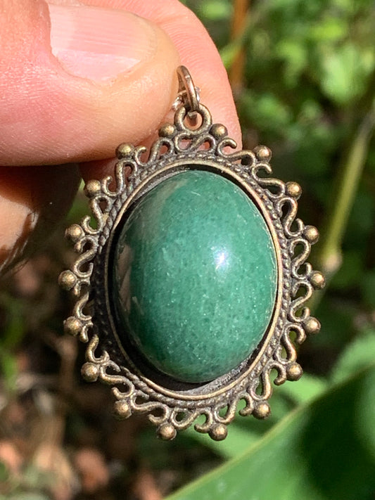 Bronze-colored medallion with Aventurine/green quartz, 36 mm high x 30 x 3. Sold with an adjustable black cord!