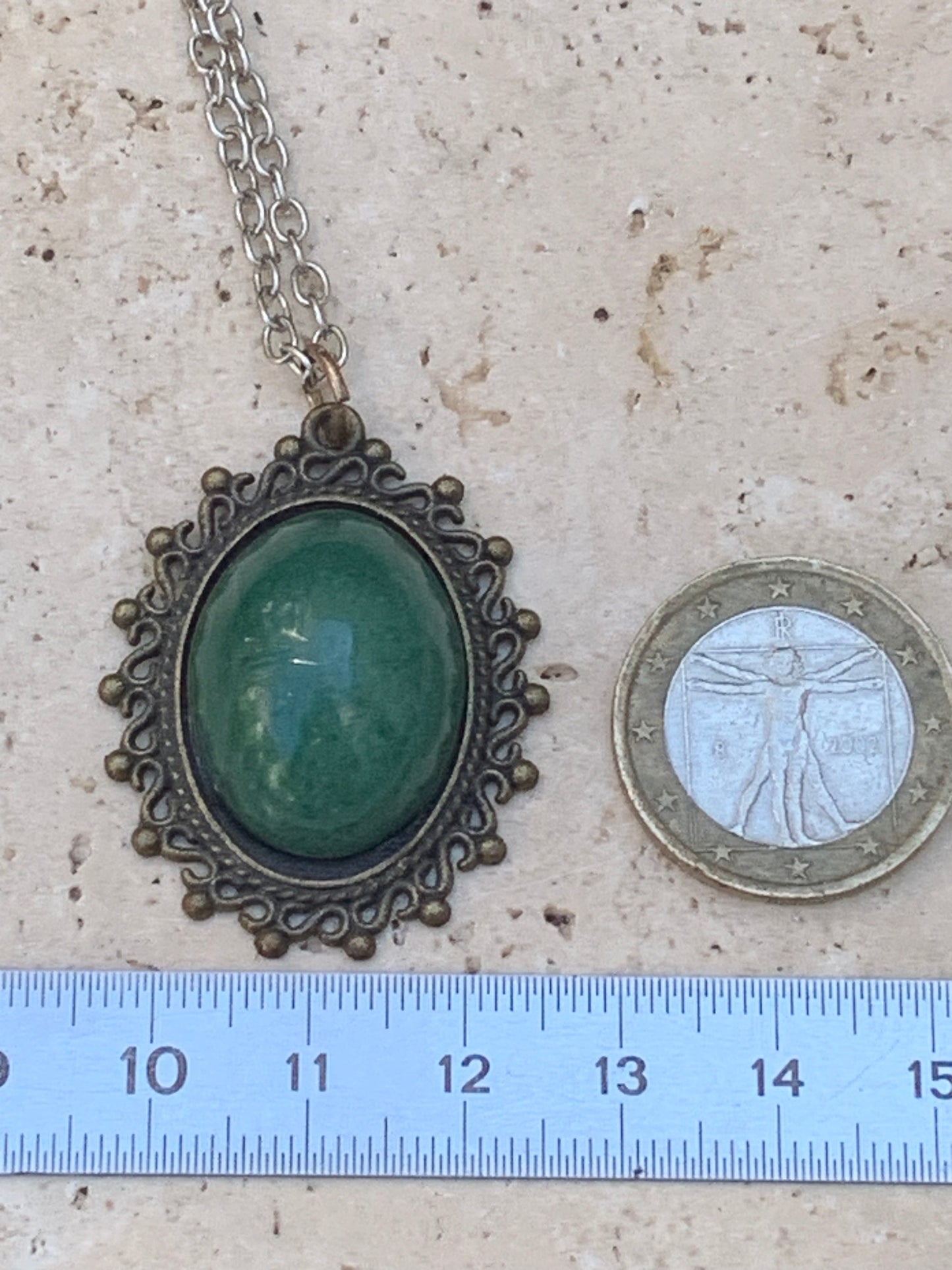 Bronze-colored medallion with Aventurine/green quartz, 36 mm high x 30 x 3. Sold with an adjustable black cord!