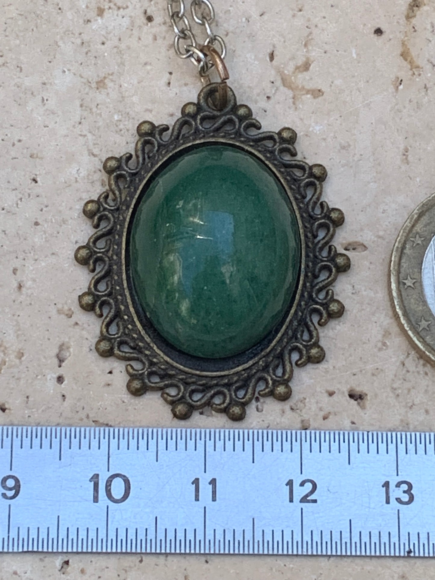 Bronze-colored medallion with Aventurine/green quartz, 36 mm high x 30 x 3. Sold with an adjustable black cord!