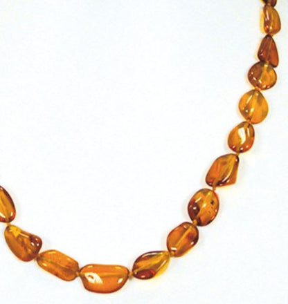 Cognac-colored amber, free-form, natural beads measuring 15 to 20 millimeters, sold in a 45 to 50 centimeter necklace. Amber screw clasp system. AA to AAA quality, superb beads, lightweight and incredibly soft!